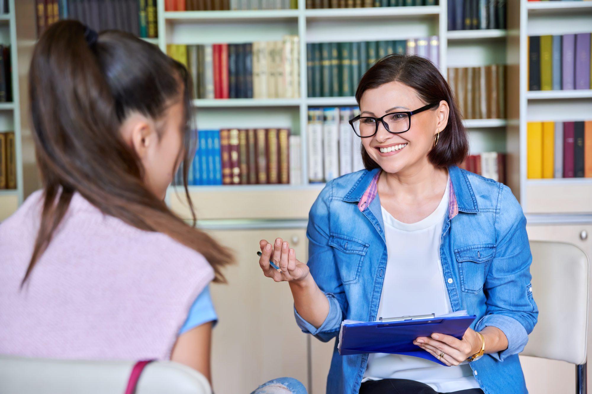 A female mentor asking some questions to another female student.